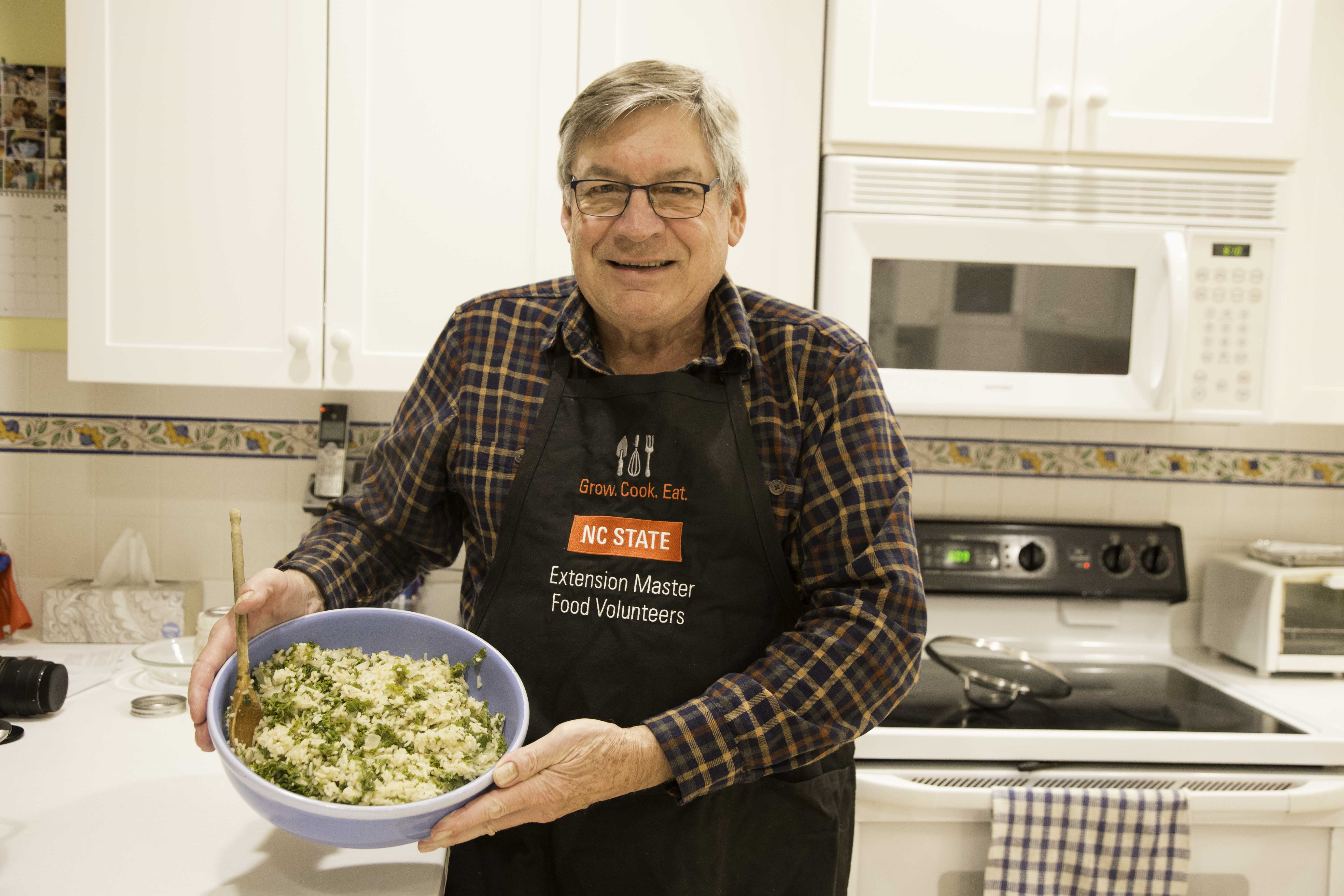 extension master food volunteering holding dish he prepared