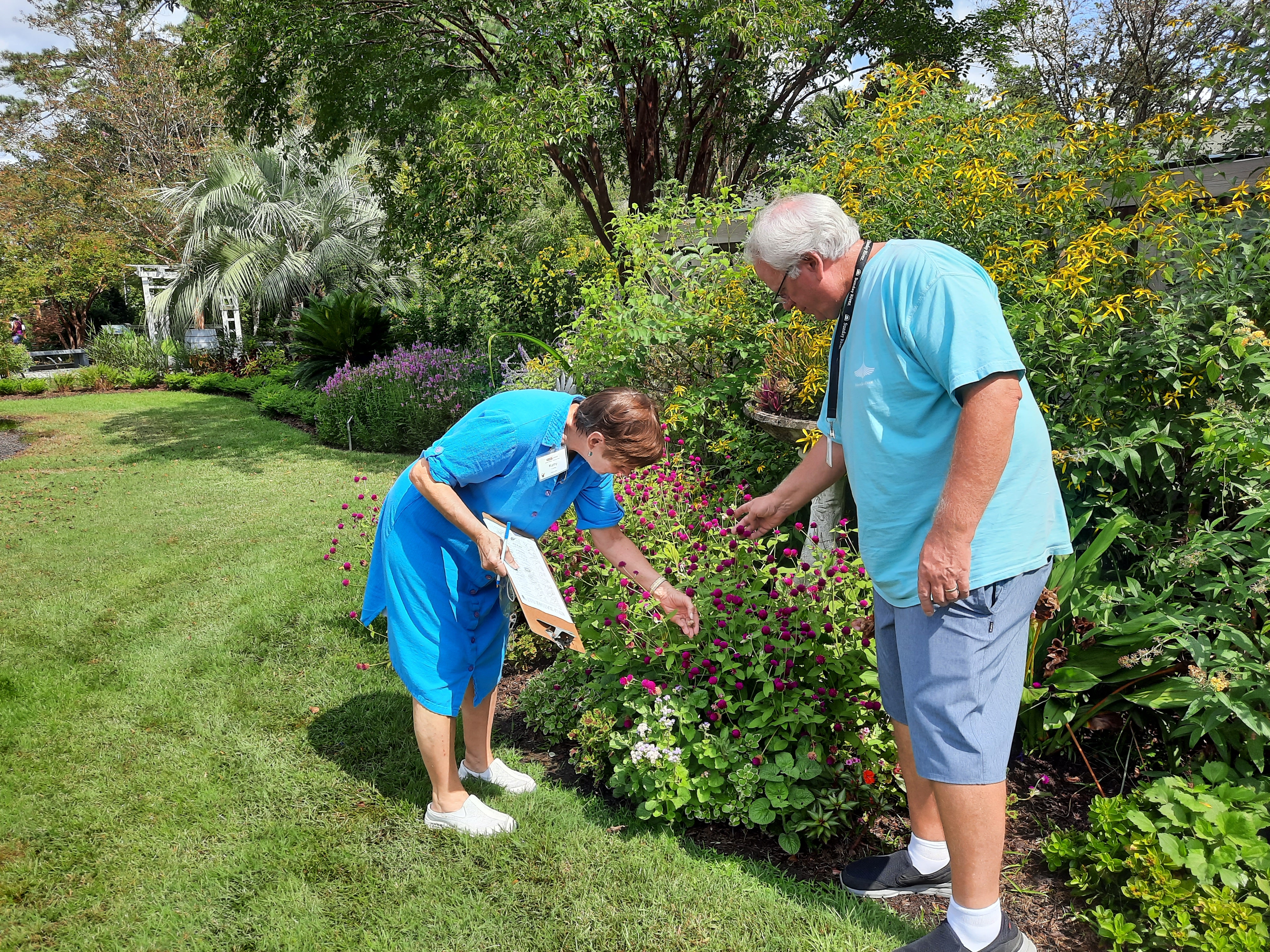 two EMGV students examining a plant during botany scavenger hunt