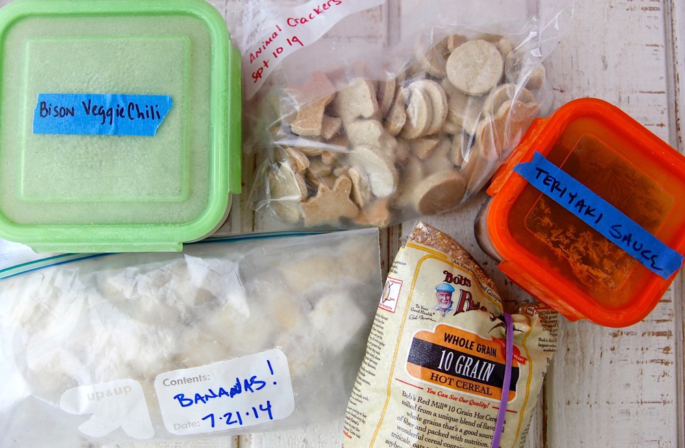 Various food storage containers labeled with their contents and the date they were stored.