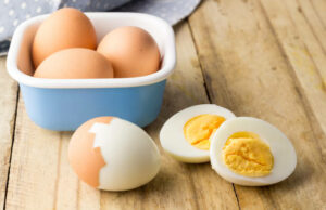 Hard boiled chicken eggs on rustic wooden table