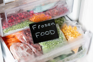 Plastic bags with different frozen vegetables in refrigerator. Frozen Food. Food storage