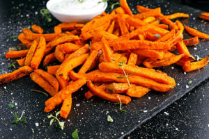 Healthy Homemade Baked Orange Sweet Potato Fries with fresh cream dip souce, herbs, salt and pepper