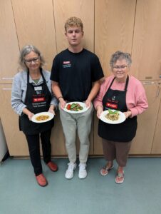 Recipe testing for Cooking for One classes Extension Master Food Volunteer Jane Kulesza (l) and Margarete O'Leary (r) with UNCW Intern Matthew Walker at the Extension Demonstration Kitchen