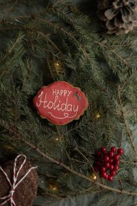 Christmas tree with a 'Happy Holiday's' ornament hanging on the tree