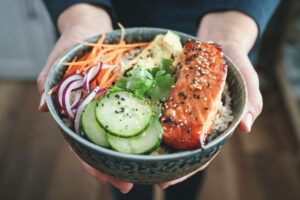 Spicy Salmon Bowl with Rice, Carrots, Cucumber and Avocado